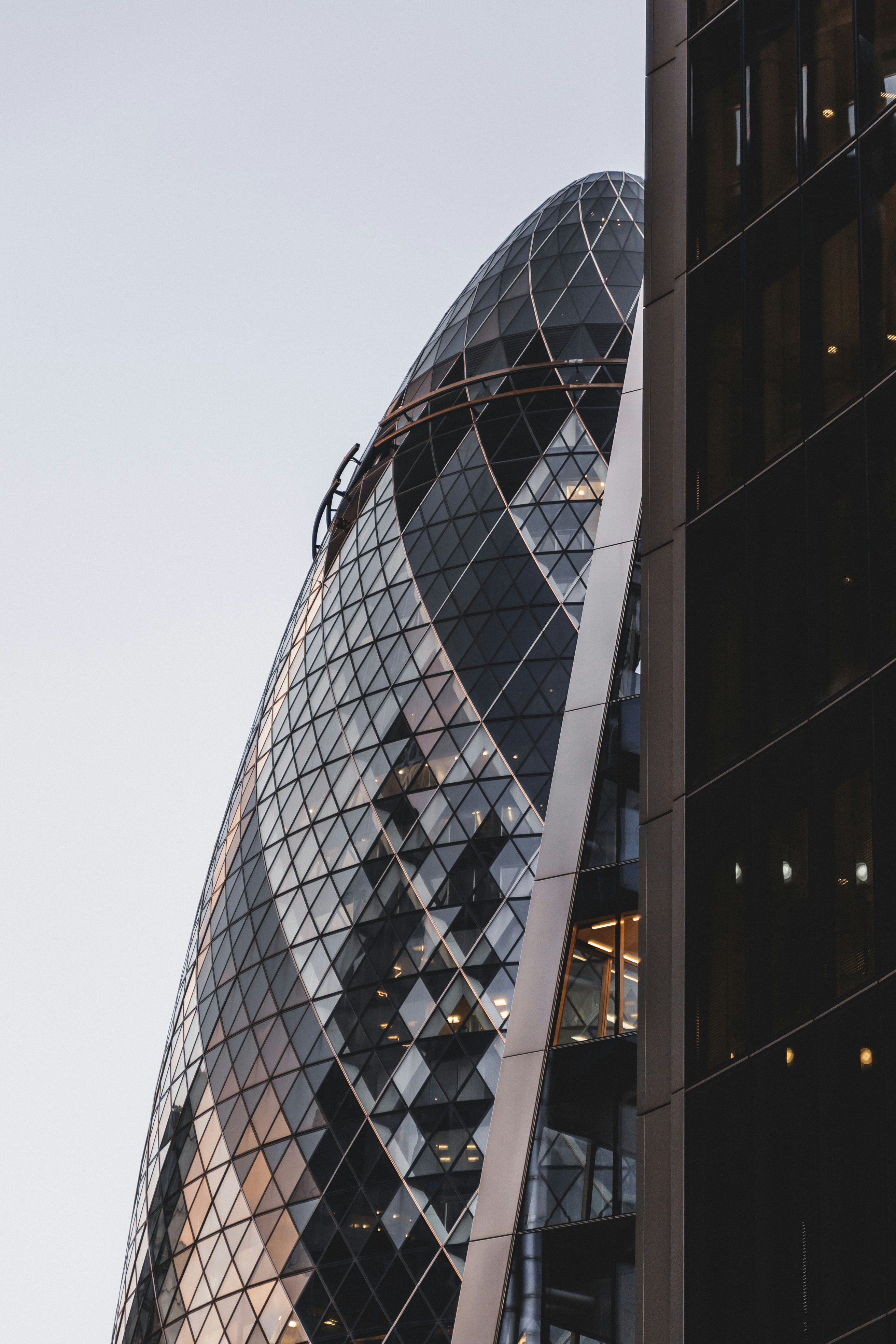 black glass walled building under white sky during daytime